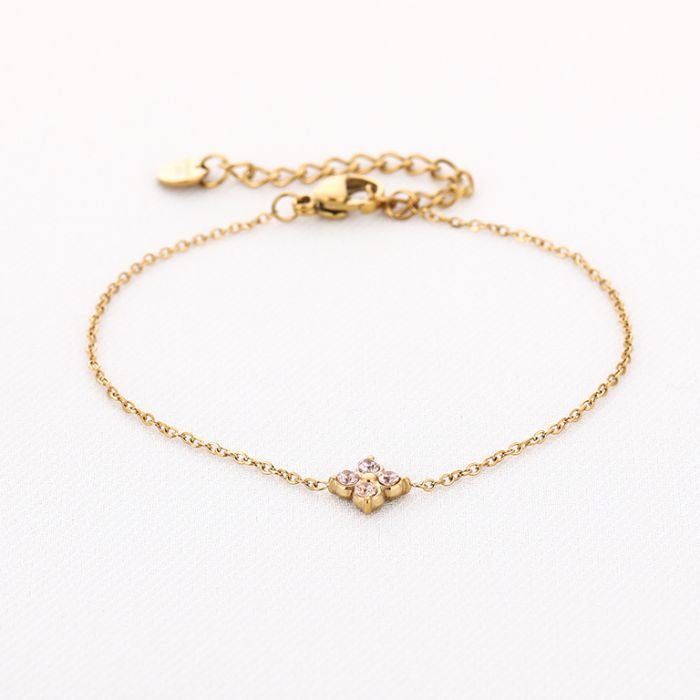 Klaver met oranje steentjes armband goud